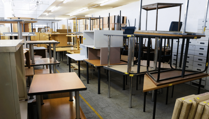 room filled with desks, tables and chair for removal